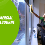 Choose a Commercial Cleaner in Melbourne | Spiffy Clean - Commercial & Office Cleaning Services Cleaner in green and black uniform wipes a large office window; left side features a bright green shape with the text 'Choose a commercial cleaner in Melbourne'.